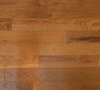 Solid hardwood in utility grade from really cheap floors this picture is a zoom in photo of their gunstock color with a distressed surface texture and wood grain 