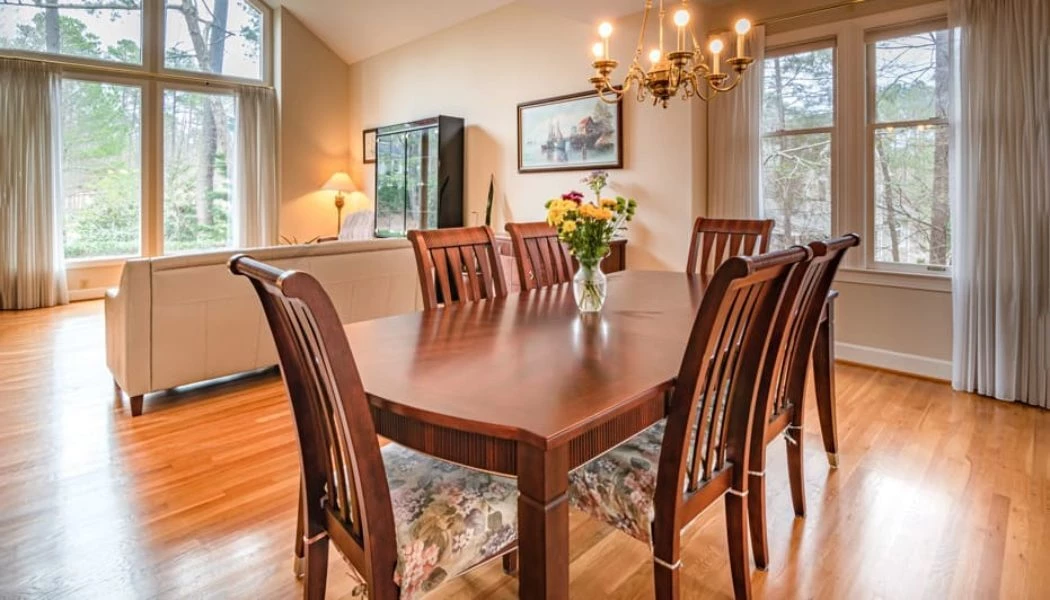 A modern living room showcasing engineered hardwood flooring in a warm oak finish