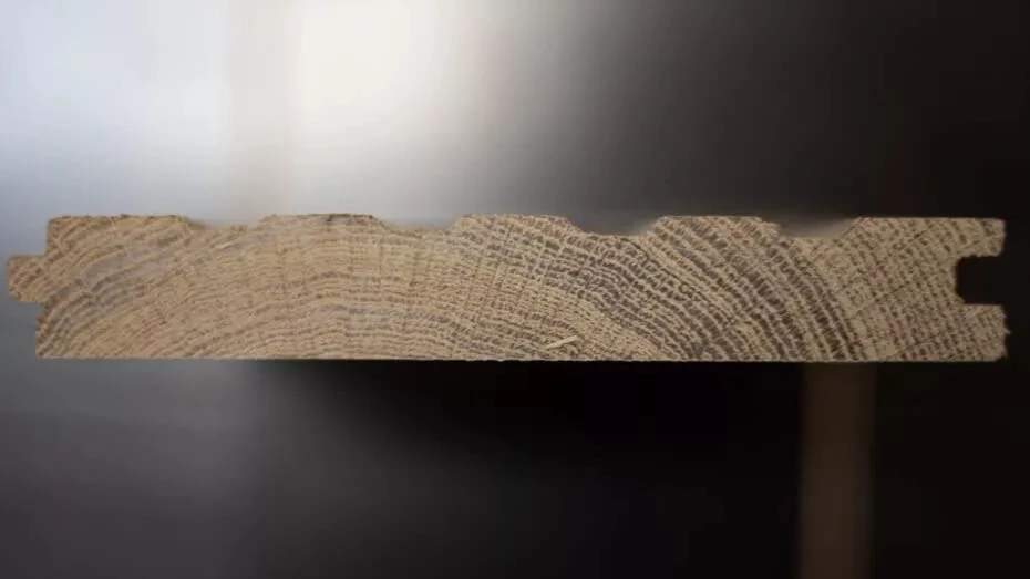 Solid hardwood cross-section showing single-piece construction compared to engineered layers