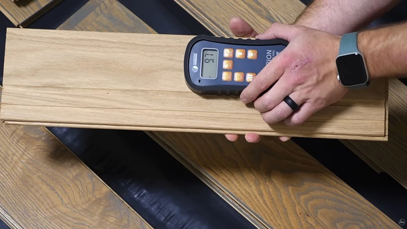 Moisture meter used to check wood before flooring installation