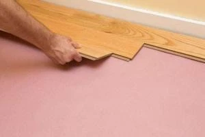 Professional applying adhesive for glue-down installation